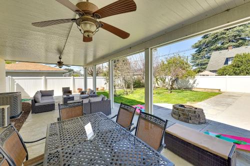 a patio with a table and chairs and a ceiling fan at 4 Mi to Dtwn Riverside Gem with Pool and Game Room in Riverside