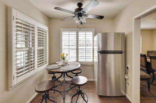 a kitchen with a table and a refrigerator at 4 Mi to Dtwn Riverside Gem with Pool and Game Room in Riverside