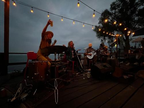 a group of people playing music on a stage at Del Lago Atitlan in San Marcos La Laguna