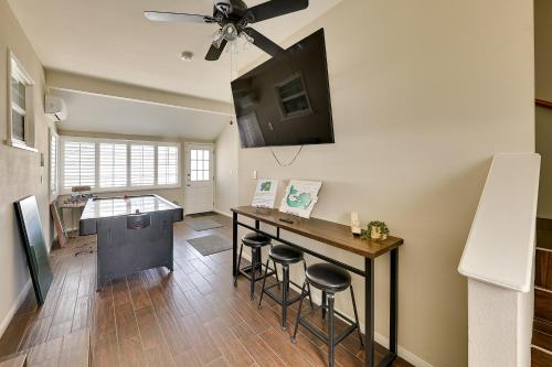 a kitchen with a bar with stools and a ceiling fan at 4 Mi to Dtwn Riverside Gem with Pool and Game Room in Riverside