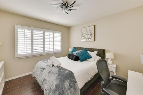 a bedroom with a bed with a chair and a window at 4 Mi to Dtwn Riverside Gem with Pool and Game Room in Riverside