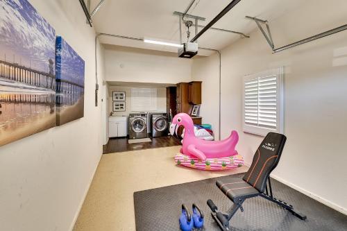 a room with a gym with a pink elephant and a chair at 4 Mi to Dtwn Riverside Gem with Pool and Game Room in Riverside