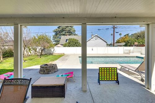 a screened in porch with chairs and a pool at 4 Mi to Dtwn Riverside Gem with Pool and Game Room in Riverside