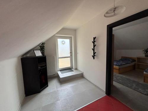 a living room with a staircase and a mirror at Atik V Borovičkách in Lipuvka