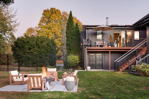 a woman sitting on a patio in front of a house at Sunset View in Portsmouth