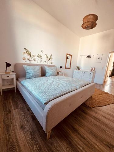 a bedroom with a bed with a blue comforter at FeWo Nordseebrise in Wilhelmshaven