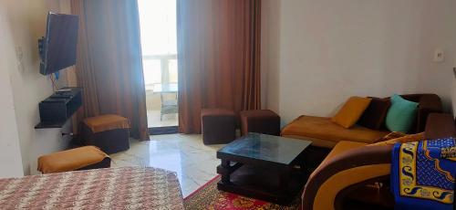 a small living room with a couch and a tv at شالية غرفتين Porto Said in Port Said