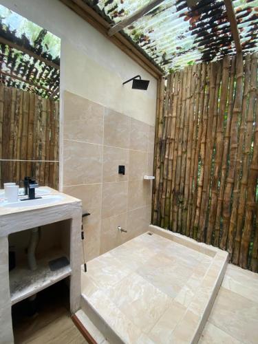 a bathroom with a sink and a shower with bamboo at Mini Jungle Villa in Manzanillo