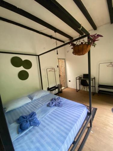 a bedroom with a bed with blue bows on it at Mini Jungle Villa in Manzanillo