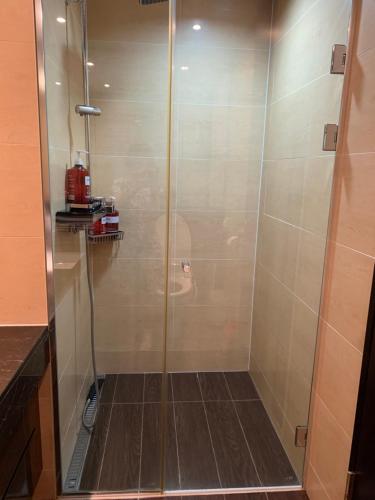 a shower with a glass door in a bathroom at Haeundae Luxury House in Busan
