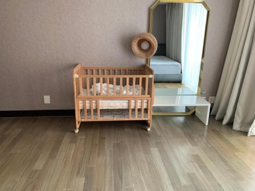 a room with a crib and a mirror at Haeundae Luxury House in Busan