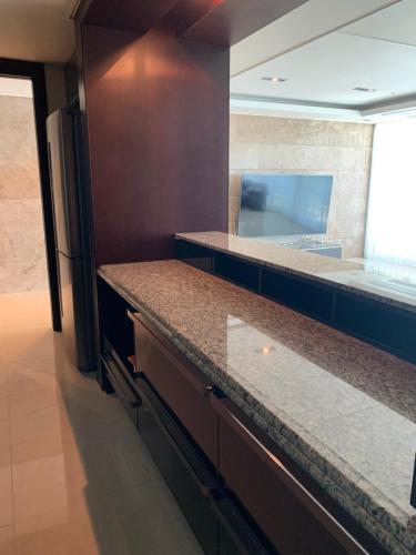 a kitchen with granite counter tops and a large window at Haeundae Luxury House in Busan
