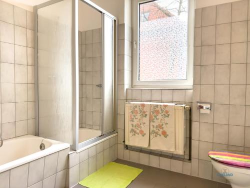a bathroom with a tub and a toilet and a sink at Landhaus Stolper Wohnung 3 in Herzberg am Harz