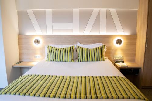 Postel nebo postele na pokoji v ubytování Hôtel Restaurant Au Boeuf