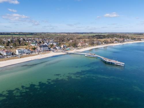 an aerial view of a beach with a pier at Strandallee - Ferienapartments direkt am Strand von Haffkrug in Haffkrug