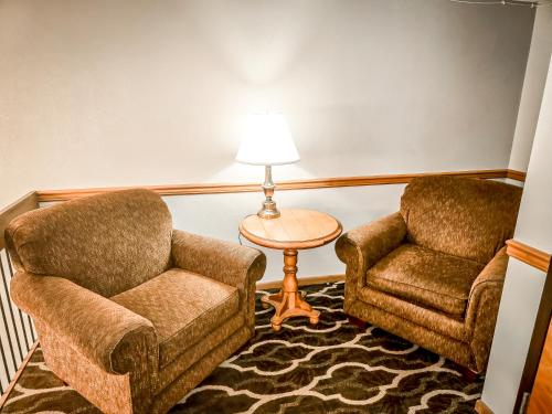 two chairs and a table and a lamp in a room at Quality Inn Selinsgrove in Selinsgrove