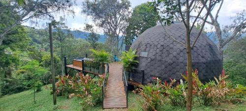 a large dome house with a staircase in front of it at Tambo Eco Hotel in La Vega