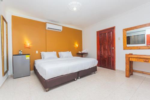 a bedroom with a large bed and a fireplace at Hotel Baluarte Cartagena Boutique in Cartagena de Indias