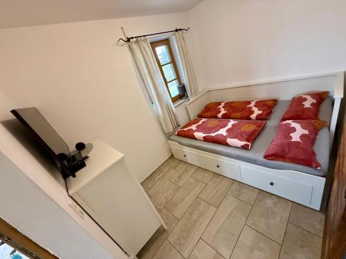 a small bedroom with a bed and a window at Ferienwohnung Jahnel in Waging am See