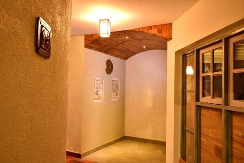 a hallway of a building with a room with a door at Mistletoe Homestay & Cafe in Munnar
