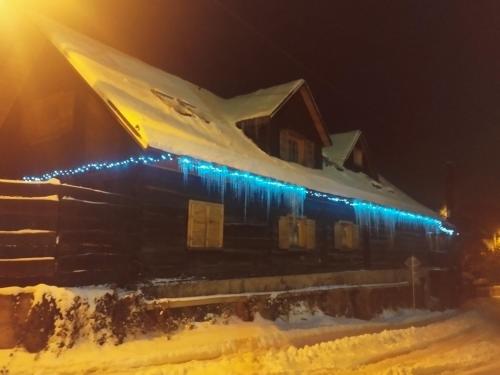 a train station covered in snow at night at Drevenica u Holtana in Oščadnica