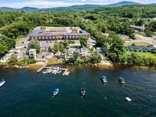 an aerial view of a resort with boats in the water at Paugus Bay Condo Close to it All in Laconia