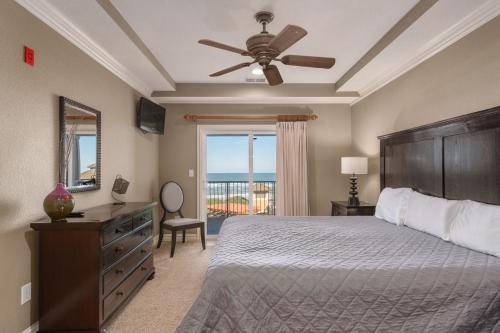 a bedroom with a bed and a ceiling fan at CSC3R - Tres Bien in Kill Devil Hills