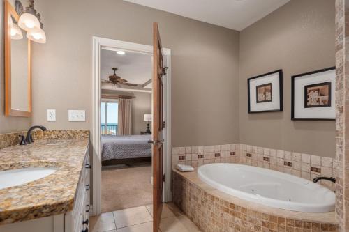 a bathroom with two sinks and a bath tub at CSC3R - Tres Bien in Kill Devil Hills