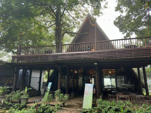 a tree house with a deck on top of it at Telaga Warna in Tengahgirang