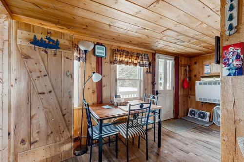 a dining room with a table and chairs in a cabin at Lily's Pad in Greenville