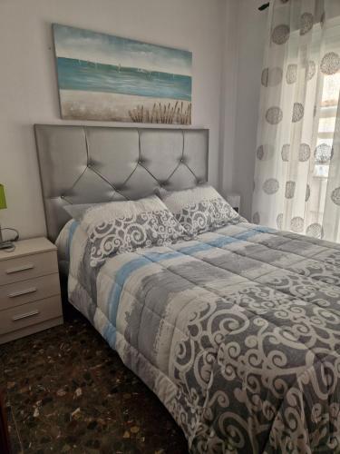a bedroom with a large bed and a window at Alfer in Cazorla