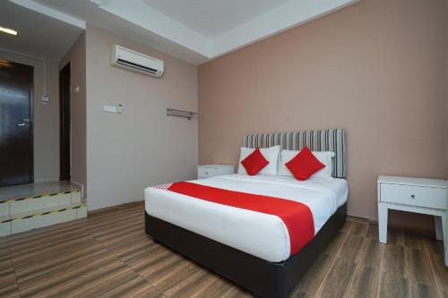 a bedroom with a large bed with red pillows at New Bangi Gateway Hotel in Bangi