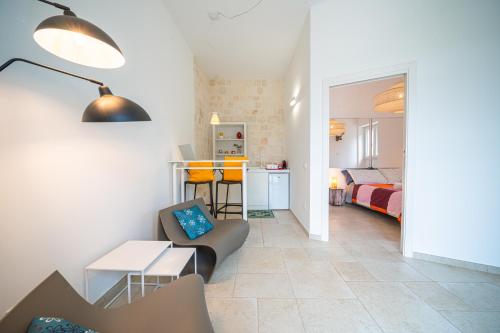 a living room with a couch and a table at Pool & Private Parking DONNA LINA in Conversano