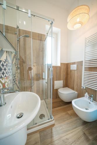 a bathroom with a sink and a glass shower at Pool & Private Parking DONNA LINA in Conversano