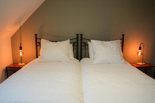 En eller flere senge i et værelse på Les Hauts de Bergheim