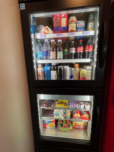 a refrigerator filled with lots of food and drinks at Spark by Hilton Opelousas in Opelousas