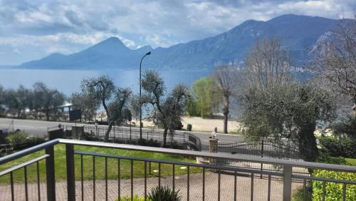 a balcony with a view of a lake and mountains at Villa Josefine Lake Front - Adults Only in Brenzone sul Garda
