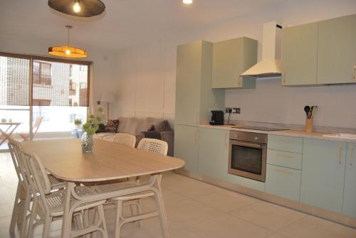 a kitchen with a table and chairs in a kitchen at Natural Ambience apartment NEW in St. Paul's Bay