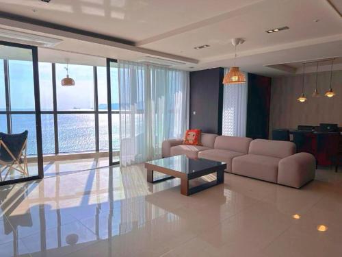 a living room with a couch and a table at Haeundae Luxury House in Busan