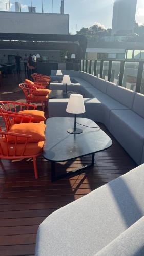 a row of tables and chairs on a balcony at Frente Mar de Cabo Branco - Setai Edition in João Pessoa