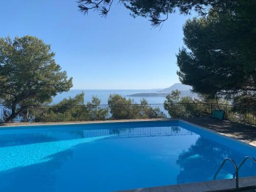 a swimming pool with a view of the water at Vista dall' Eden in Mortola Superiore