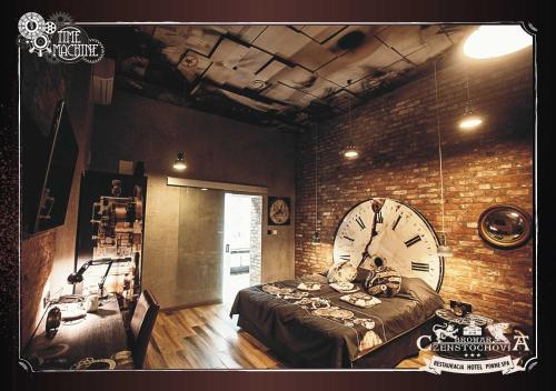 a room with a large clock on a brick wall at Browar CzenstochoviA Hotel&Spa in Częstochowa