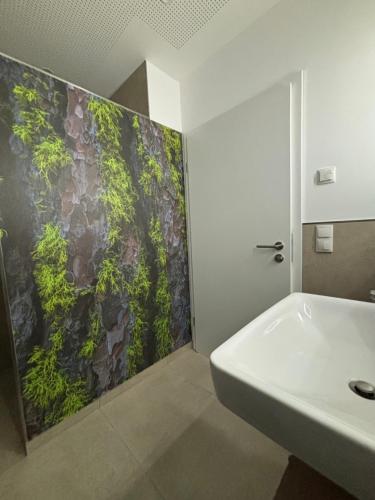 a bathroom with a sink and a green wall at Birke in Nortrup