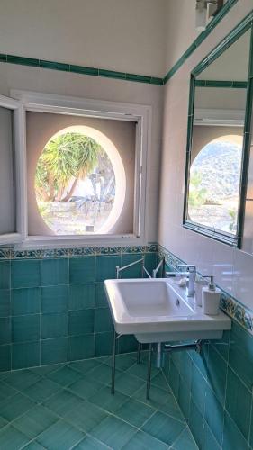 a bathroom with a white sink and a window at Mamma Wanda Sea View Home Amalfi Coast in Vietri sul Mare