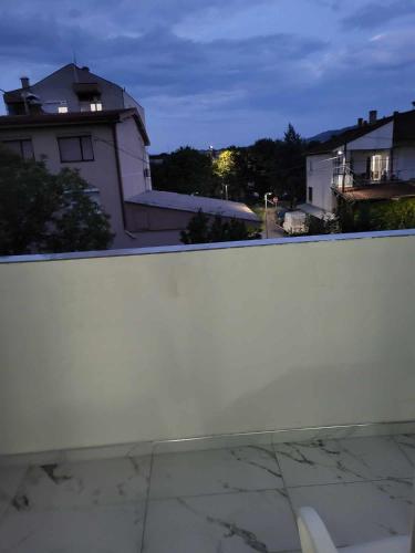 a white wall in front of a building at Jordanovi Premium Apartment in Kavadarci