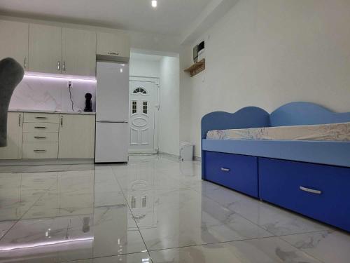 a large kitchen with a blue bed in a room at Jordanovi Premium Apartment in Kavadarci