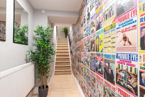 a hallway with a wall covered in movie posters at Starbeck Serviced Apartments in Harrogate