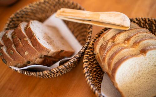 a basket with bread and a wooden spoon on a table at Line Hotel Patagonia in Puerto Natales