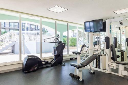 a gym with cardio equipment and a large window at Solara Surfside in Miami Beach