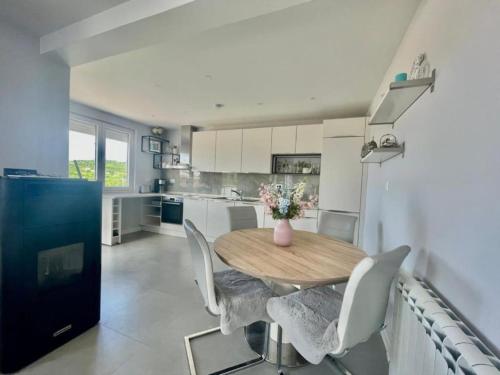 a kitchen with a wooden table and chairs and a refrigerator at Family Apartments Stefan in Budva
